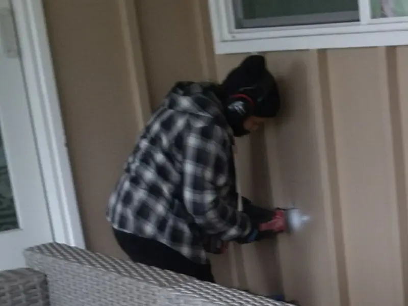Professional electrician installing an exterior outlet in Longmont
