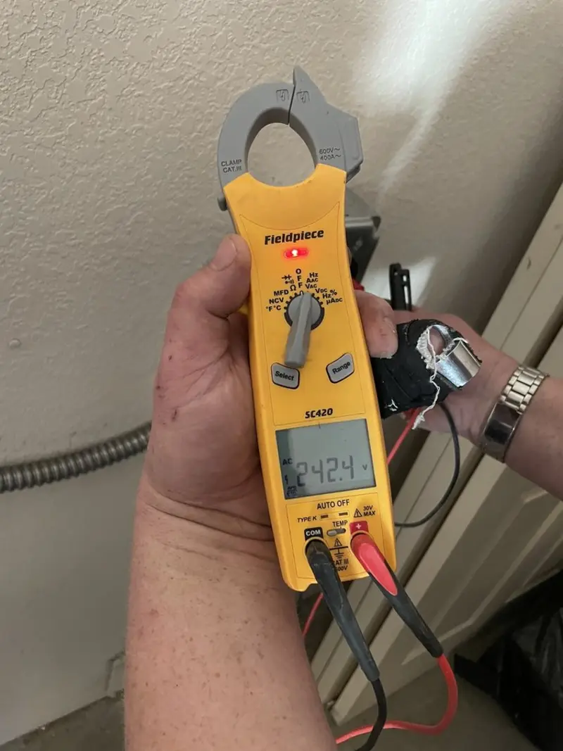 Voltage testing with clamp meter during Recessed Lighting Installation in Longmont